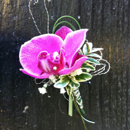 Pink orchid corsage with white accents and curled wire details