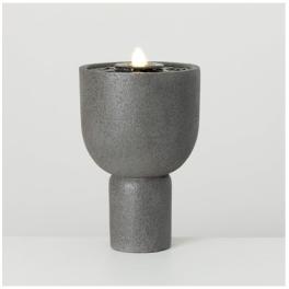 Gray pedestal candle holder with a lit candle