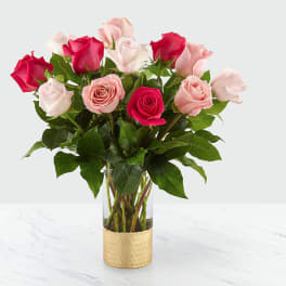 Bouquet of pink and red roses in a clear glass vase