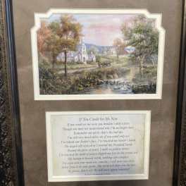 Framed landscape print above a memorial poem plaque