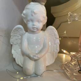 White ceramic angel figurine with wings and folded hands