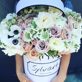 Large pastel bouquet in a white hatbox with roses and white blooms