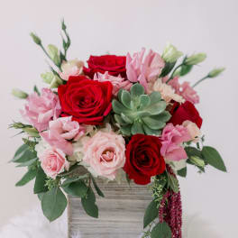 Pink and red rose bouquet with a succulent in a wooden box