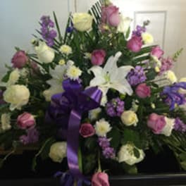 Large mixed bouquet with white lilies, roses, and purple flowers