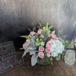 Pink and white floral arrangement in a glass vase