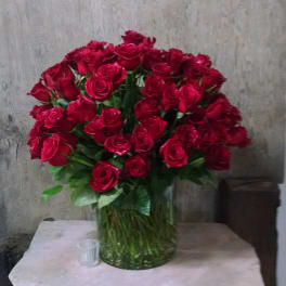 Large bouquet of red roses in a clear glass vase