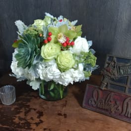 Mixed bouquet in a glass vase with white and green flowers