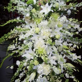 Large white floral spray with lilies and orchids