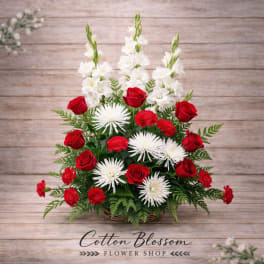 Basket arrangement of red roses, white spider mums, and white gladiolus