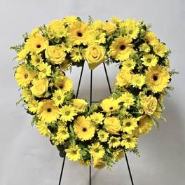 Yellow flower wreath on a black stand