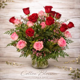 Bouquet of red and pink roses in a clear glass vase