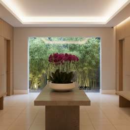 Purple orchids in a white bowl on a table