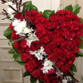 Heart-shaped red floral spray with white accents and roses