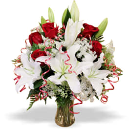 Bouquet of red roses and white lilies in a glass vase