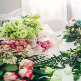 Assorted bouquets of roses and white flowers on a table