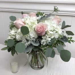Pink roses and white hydrangeas in a glass vase