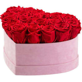 Heart-shaped box of red roses with a pink wrap