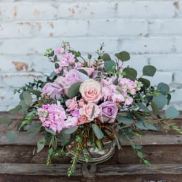 Pink and lavender rose bouquet in a clear glass vase