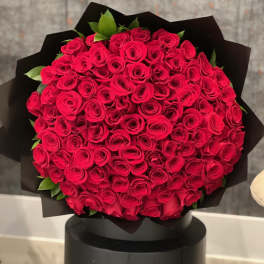 Large bouquet of red roses wrapped in black paper