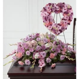 Lavender and pink floral casket spray with a matching heart wreath