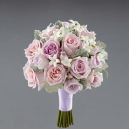 Pastel rose bouquet with white blossoms and lavender ribbon wrap