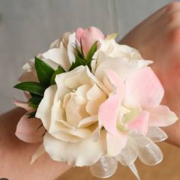 Small wrist corsage with white and pale pink flowers