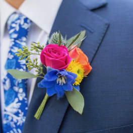 Colorful boutonniere pinned to a navy suit jacket
