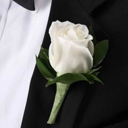 White rose boutonniere on a black suit jacket