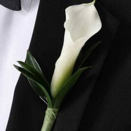 White calla lily boutonniere on a black suit jacket