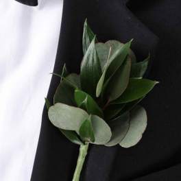 Green boutonniere pinned to a black suit jacket