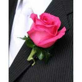Pink rose boutonniere on a black suit lapel