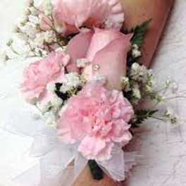 Pink corsage with white baby's breath on a wrist