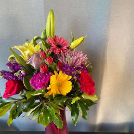 Colorful mixed bouquet in a pink glass vase