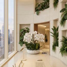 Low white bowl of cascading white orchids on a modern office desk with city skyline in the background