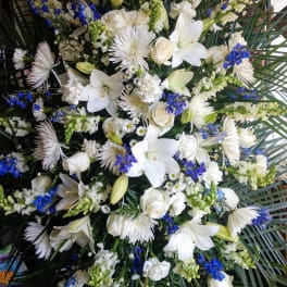 Large white and blue floral spray with lilies and roses