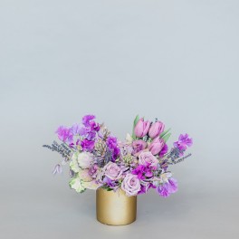 Lavender and pink bouquet in a gold cylinder vase