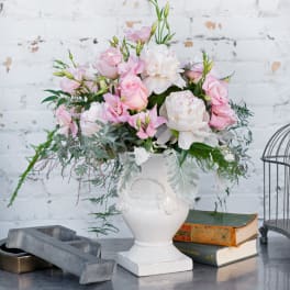 Pink and white floral arrangement in a white vase
