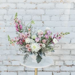 Pink and white floral arrangement in a white vase