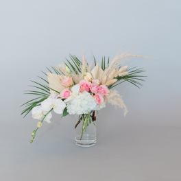 Pink roses and white orchids in a clear glass vase