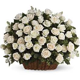 White rose arrangement in a wicker basket