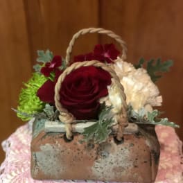 Small basket arrangement with red and white flowers