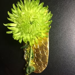 Bright green chrysanthemum boutonniere with a gold textured ribbon