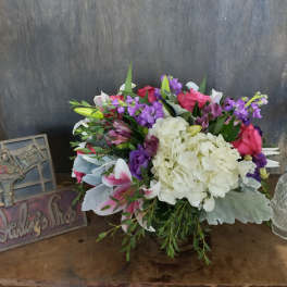 Mixed bouquet with white hydrangea, pink roses, and purple flowers