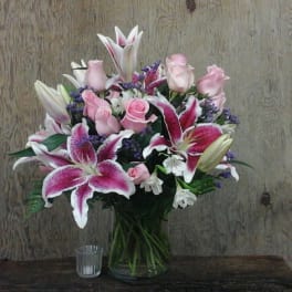 Bouquet of pink roses and lilies in a glass vase