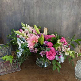 Pink and white mixed flower arrangement in a clear glass vase