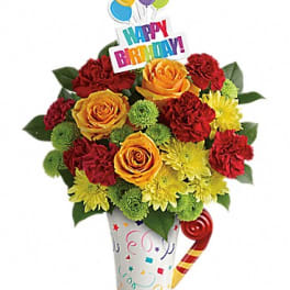 Birthday bouquet with roses, carnations, and balloons in a decorated vase
