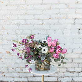 Pink tulips and white anemones in a glass vase