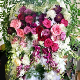Large standing floral spray with pink, purple, and white flowers
