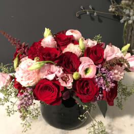 Bouquet of red and pink roses in a black vase