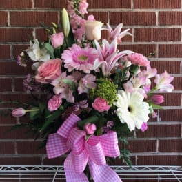 Pink and white mixed bouquet in a glass vase with a gingham bow